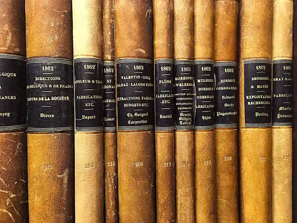 Close-up view of old records and activity reports from the Vieille Montagne archival collection